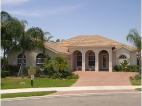 9053 Bronco Court Naples, FL 34113 - Photo 1 of 7 a view of a white house with a yard and plants