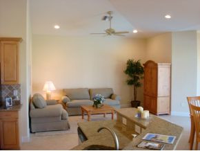 9053 Bronco Court Naples, FL 34113 - Photo 4 of 7 a living room with furniture and a chandelier