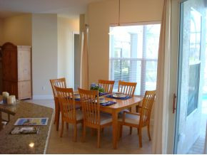 9053 Bronco Court Naples, FL 34113 - Photo 5 of 7 a dining room with furniture and window