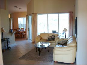 9053 Bronco Court Naples, FL 34113 - Photo 6 of 7 a living room with furniture and a large window