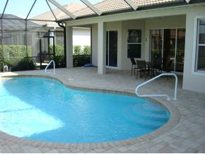 9053 Bronco Court Naples, FL 34113 - Photo 7 of 7 a view of a swimming pool with patio