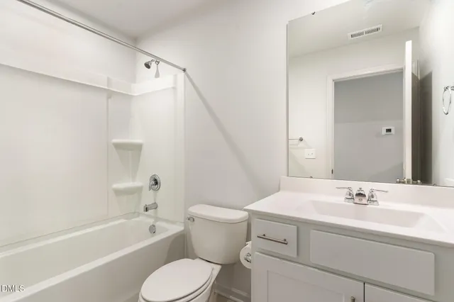 a bathroom with a sink toilet vanity and bathtub