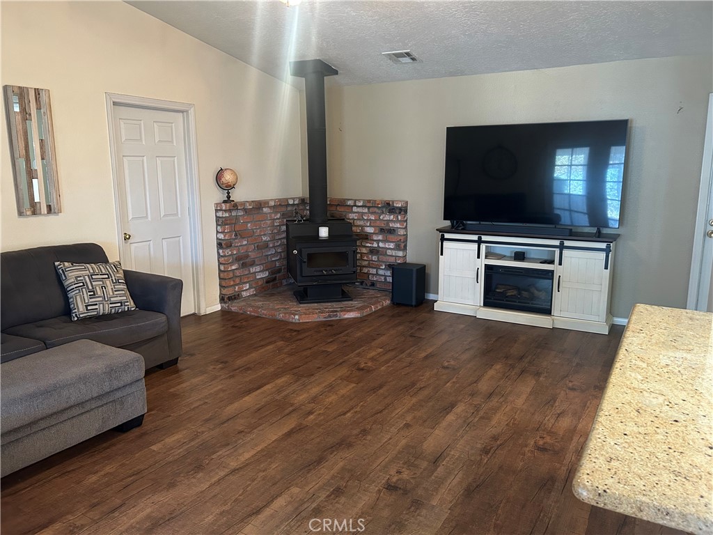 20187 Itasca Road Apple Valley, CA 92308 - Photo 19 of 35 a living room with furniture and a flat screen tv
