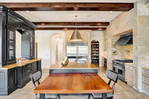 a view of a patio with a dining table and chairs with wooden floor