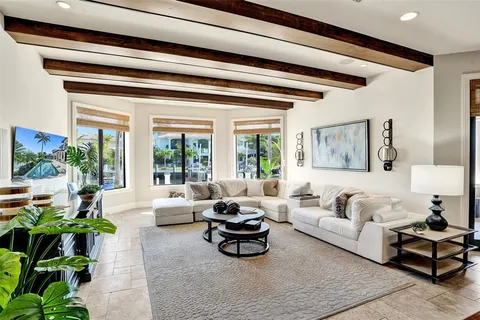 a dining room with furniture a chandelier and wooden floor