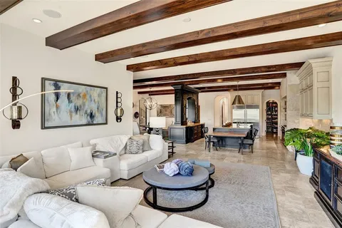 a living room with furniture a table and a chandelier