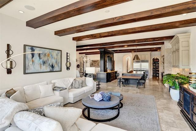 a living room with furniture a table and a chandelier