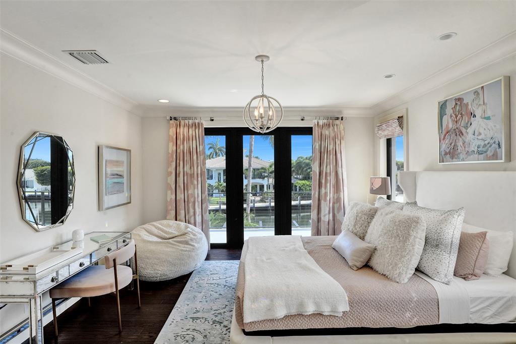 35 Compass Isle Fort Lauderdale, FL 33308 - Photo 65 of 90 a bedroom with a large bed and a chandelier