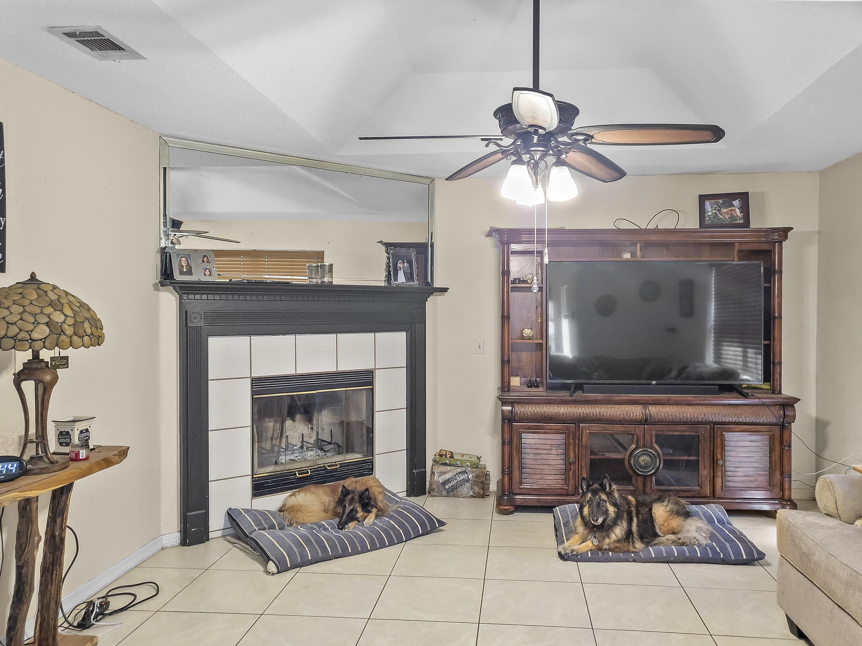 4970 East Spencer Field Road Pace, FL 32571 - Photo 6 of 15 a living room with furniture and a fireplace