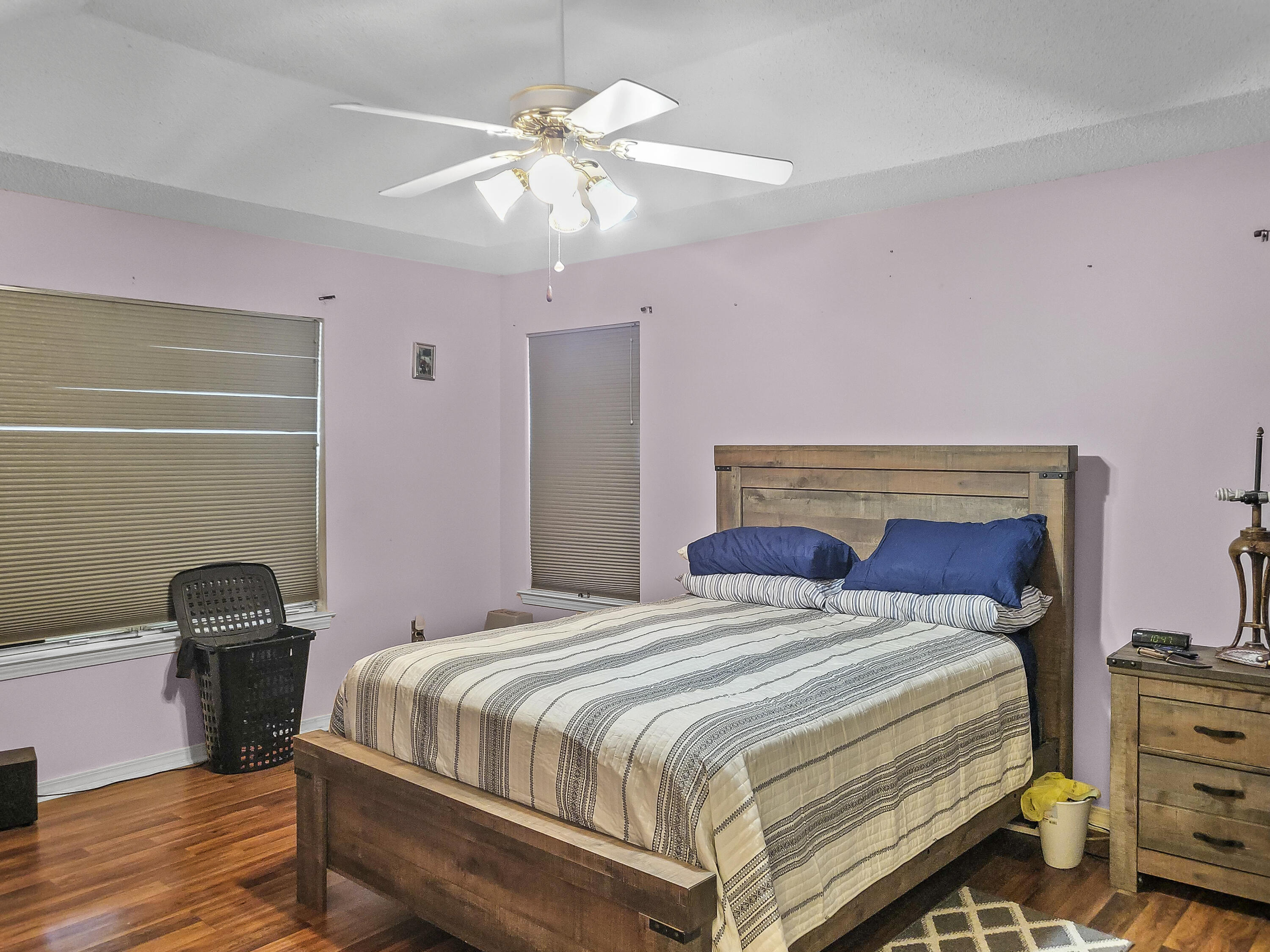 4970 East Spencer Field Road Pace, FL 32571 - Photo 8 of 15 a bedroom with a bed and a chandelier