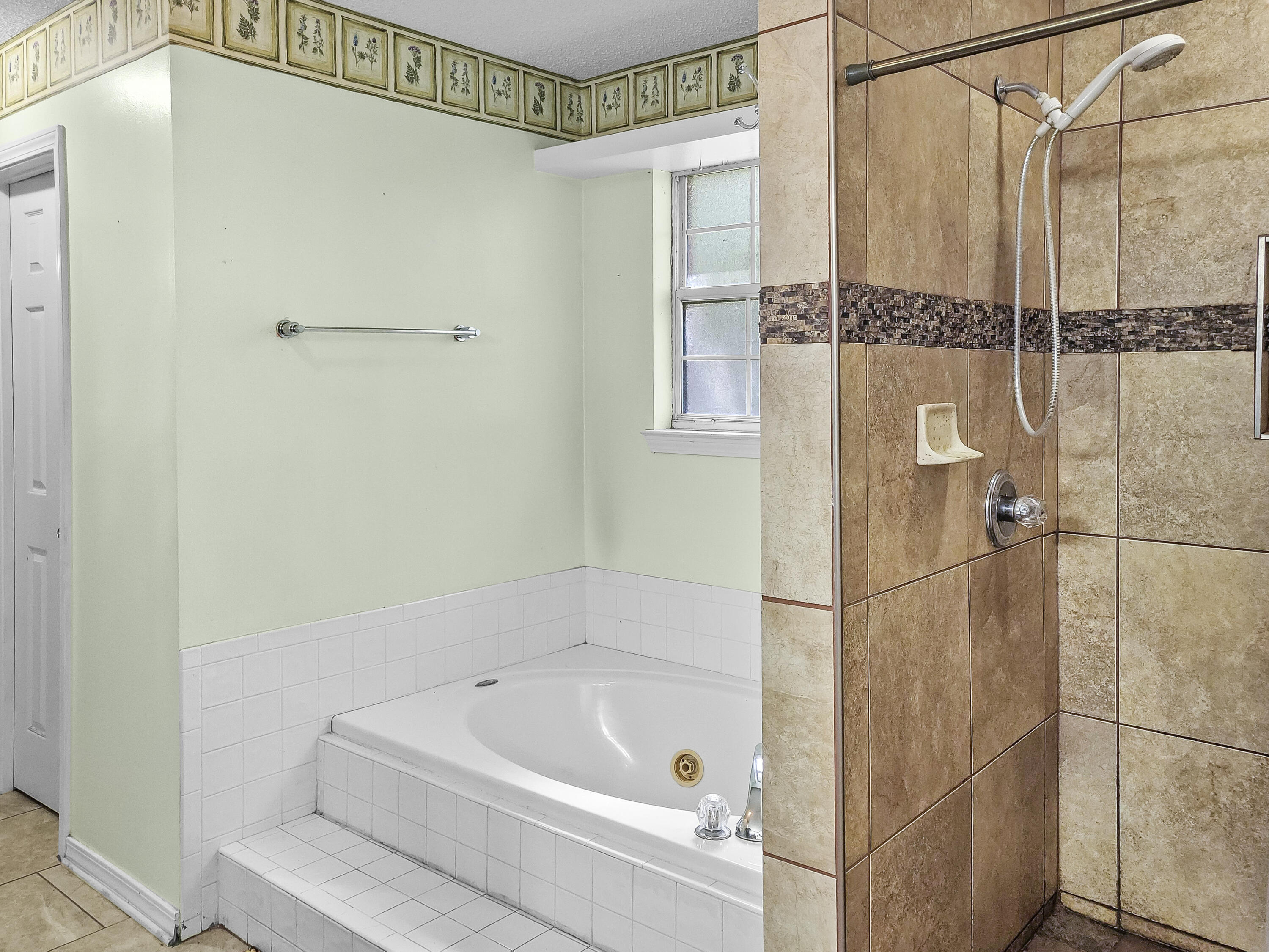 4970 East Spencer Field Road Pace, FL 32571 - Photo 10 of 15 a bathroom with a bathtub and a shower