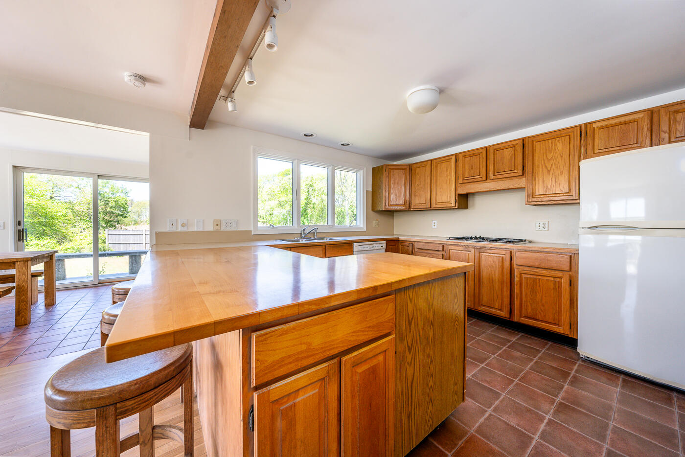 52 Captain Linnell Road Orleans, MA 02653 - Photo 11 of 41 a kitchen with a refrigerator a stove a sink dishwasher with a dining table and chairs with wooden floor