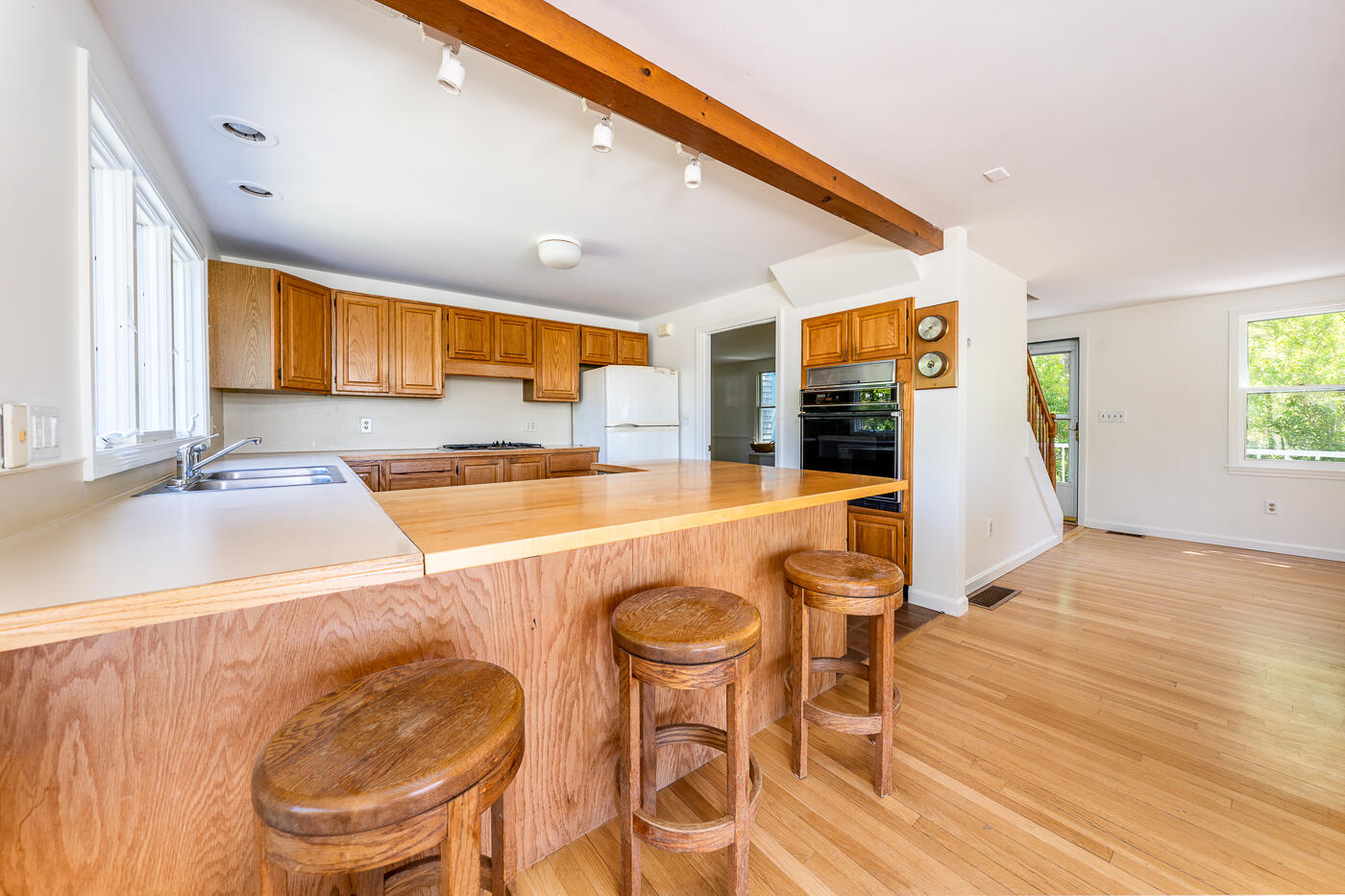 52 Captain Linnell Road Orleans, MA 02653 - Photo 15 of 41 a view of a dining room kitchen counter and hall with wooden floor
