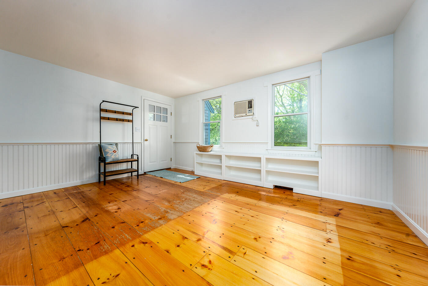 52 Captain Linnell Road Orleans, MA 02653 - Photo 21 of 41 a view of an empty room with a window and a kitchen