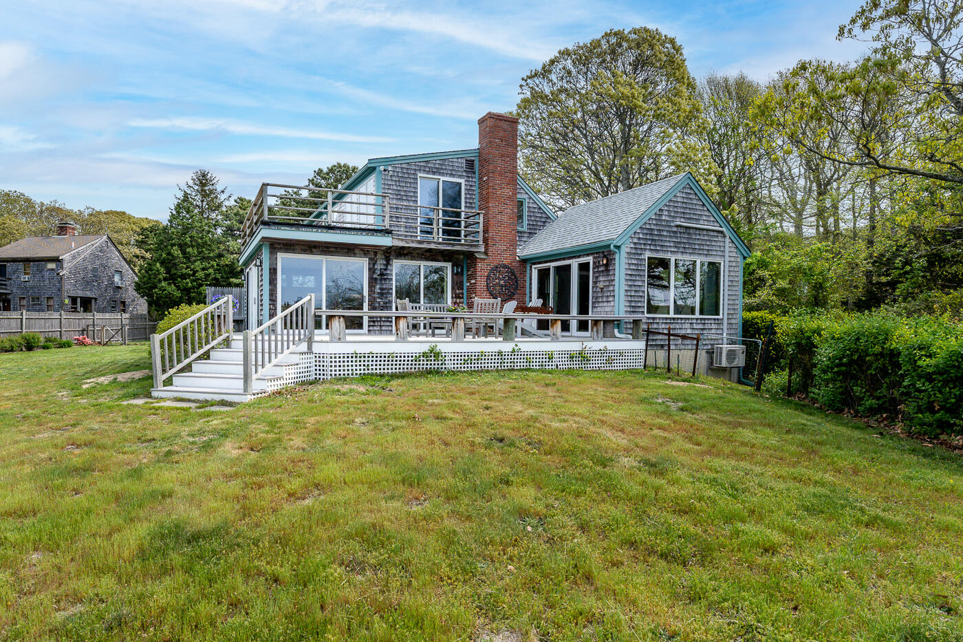 52 Captain Linnell Road Orleans, MA 02653 - Photo 34 of 41 a front view of house with yard and trees in the background