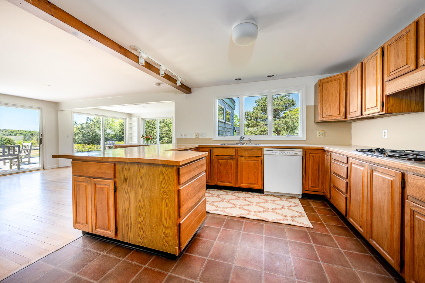 52 Captain Linnell Road Orleans, MA 02653 - Photo 10 of 41 a kitchen with stainless steel appliances granite countertop a stove a sink dishwasher and cabinets with wooden floor