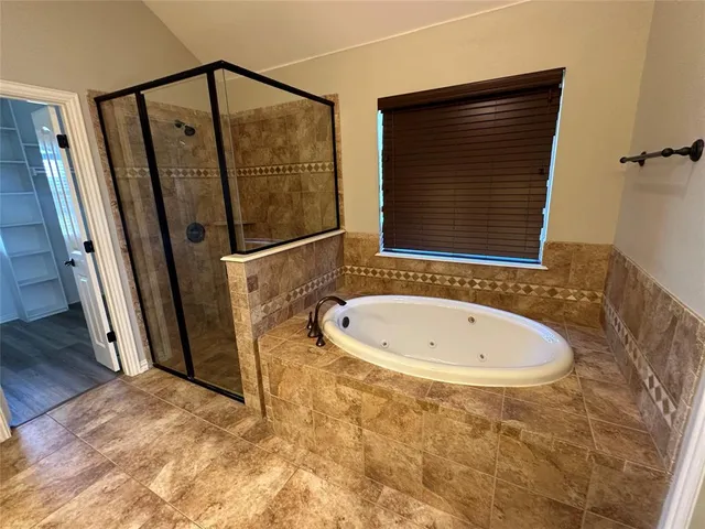 a bathroom with a bathtub and a shower