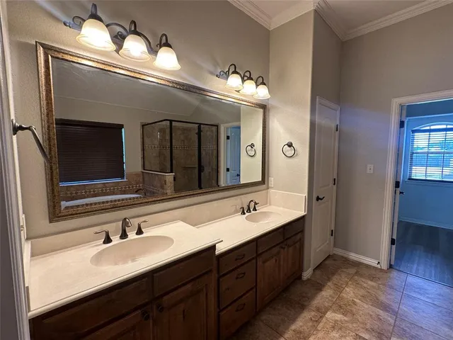 a bathroom with a double vanity sink and a large mirror