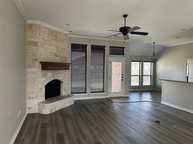 a living room with wooden floors and fireplace