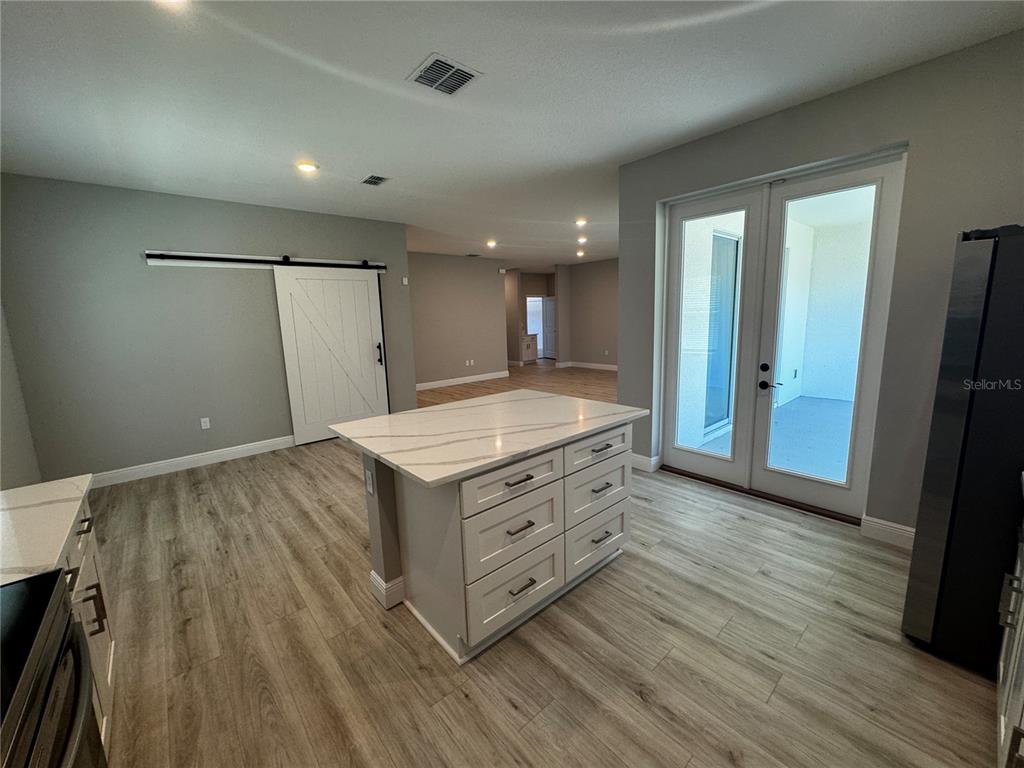 13101 Southwest 72nd Terrace Road Ocala, FL 34473 - Photo 4 of 18 a view of a hallway to room with wooden floor