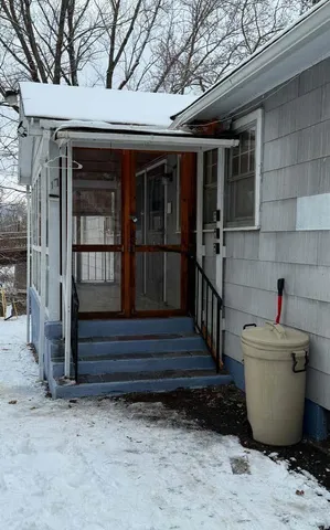 a living room with fireplace furniture and a large window