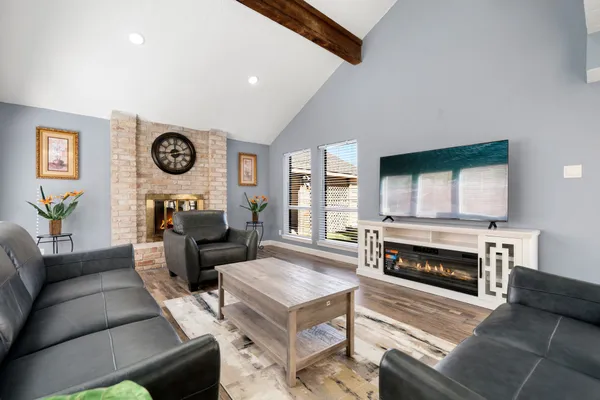 a living room with furniture a clock and a fireplace