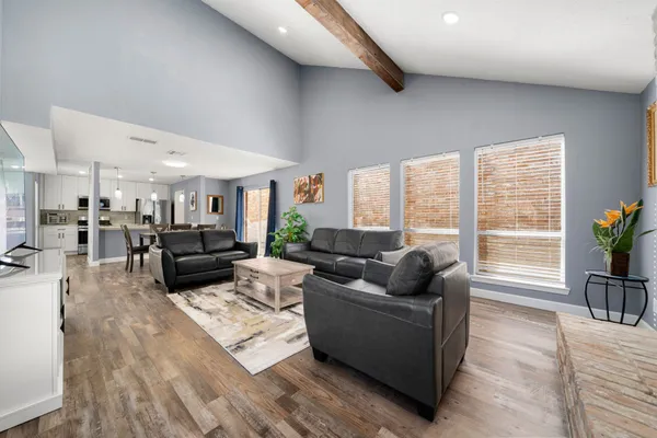 a living room with furniture and floor to ceiling windows