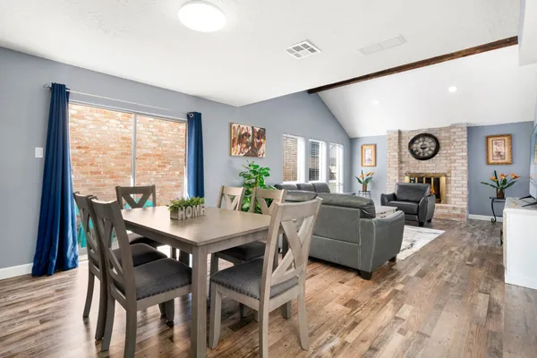 a view of a dining room with furniture and wooden floor