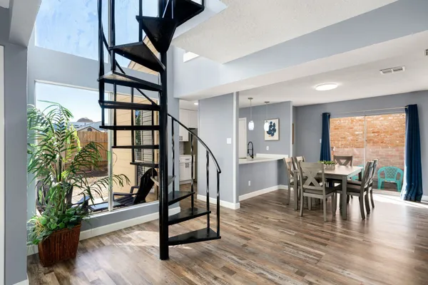 a view of a a dining room with furniture window and wooden floor