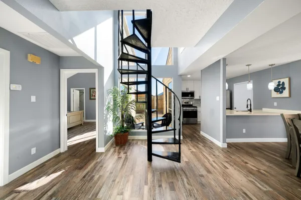 a view of entryway and hall with wooden floor