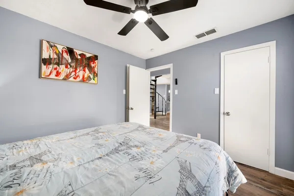 a bedroom with a large bed and a chandelier