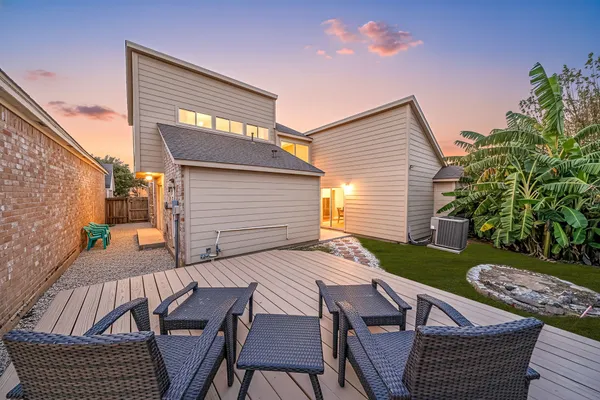 a view of a patio with table and chairs with wooden floor and fence