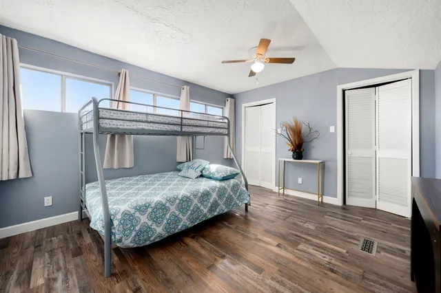 a bedroom with a bed and a chandelier