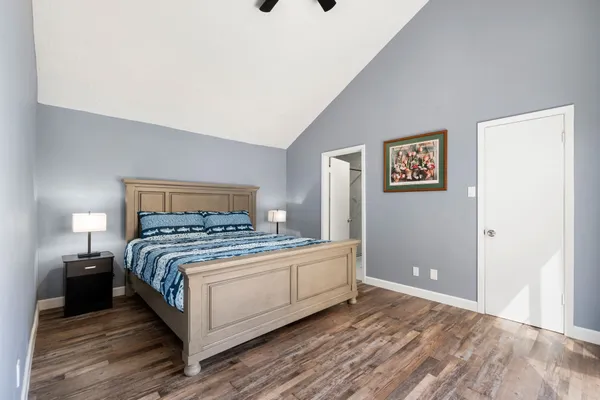 a bedroom with a bed and a night stand