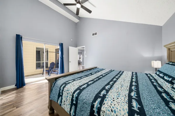 a bedroom with a bed and wooden floor