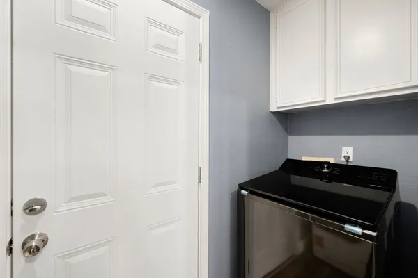 a close view of a sink and cabinets