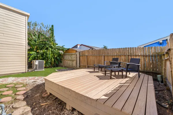 a view of a patio with table and chairs and potted plants