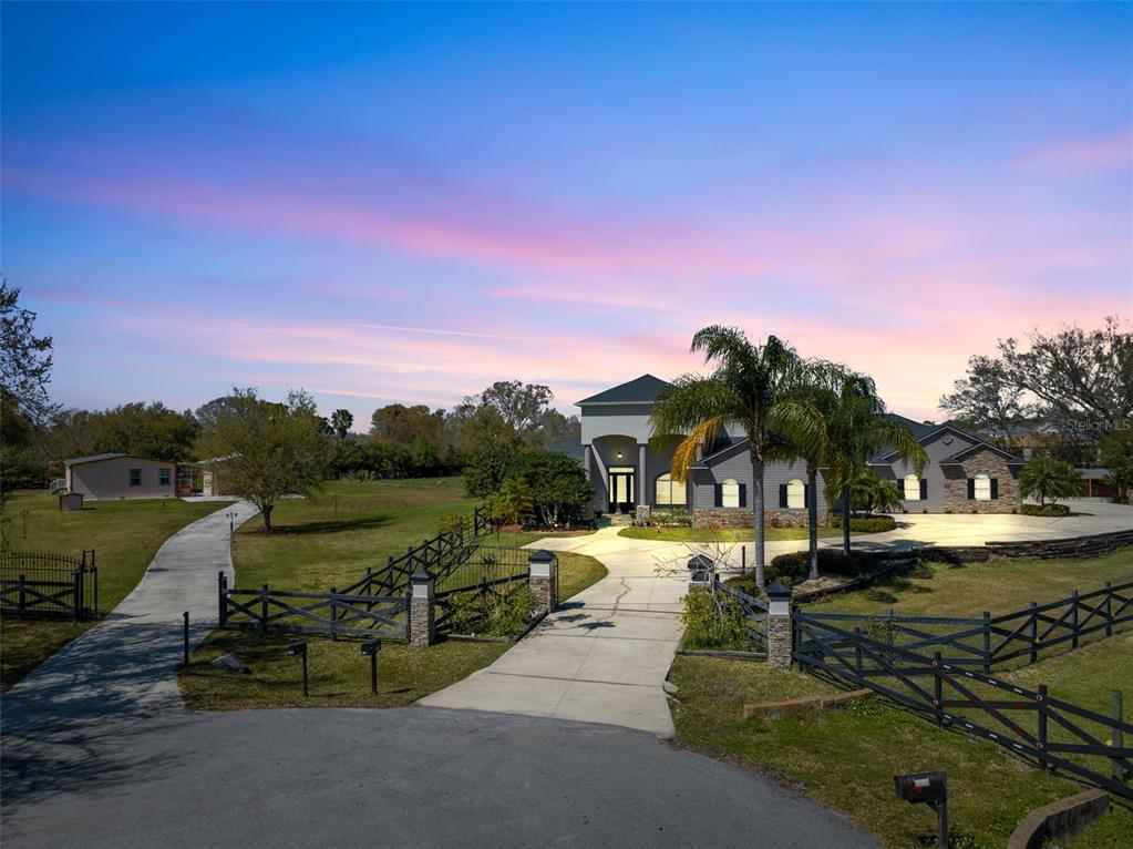 2245 Gunn Road Kissimmee, FL 34746 - Photo 1 of 1 Welcome to an unparalleled living experience where luxury meets functionality in this magnificent custom home, nestled on a sprawling 2.5-acre gated property.