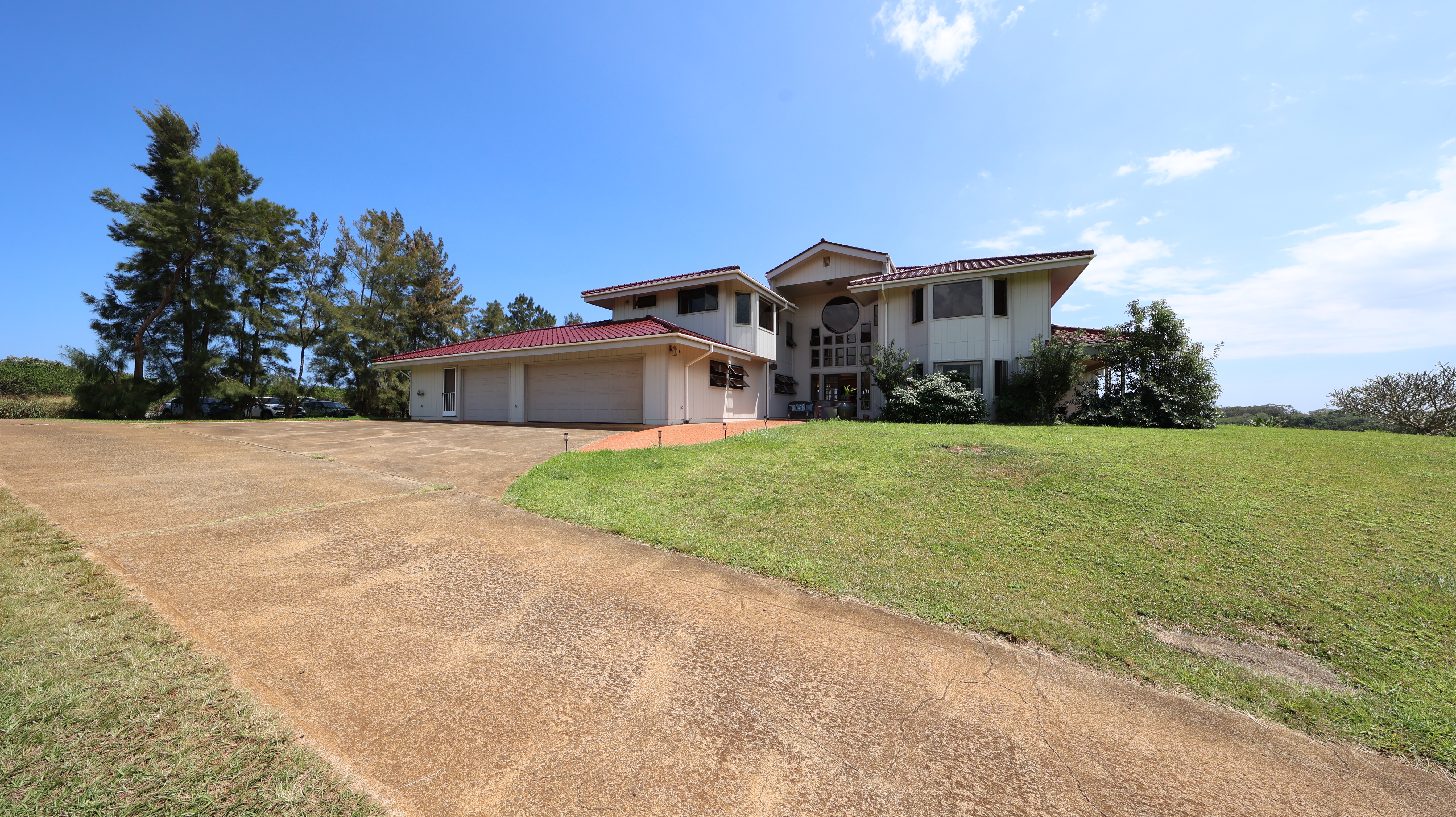 5370 Kaehulua Road Kapaa, HI 96746 - Photo 3 of 25 a front view of house with yard and car parked