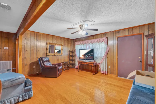 a bedroom with furniture and a flat screen tv