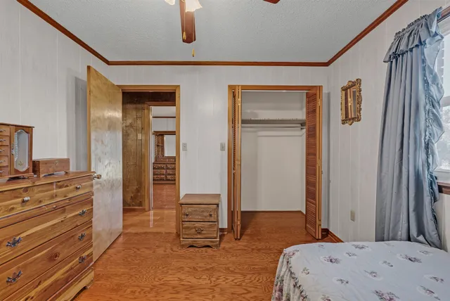 a bedroom with a bed and a dresser