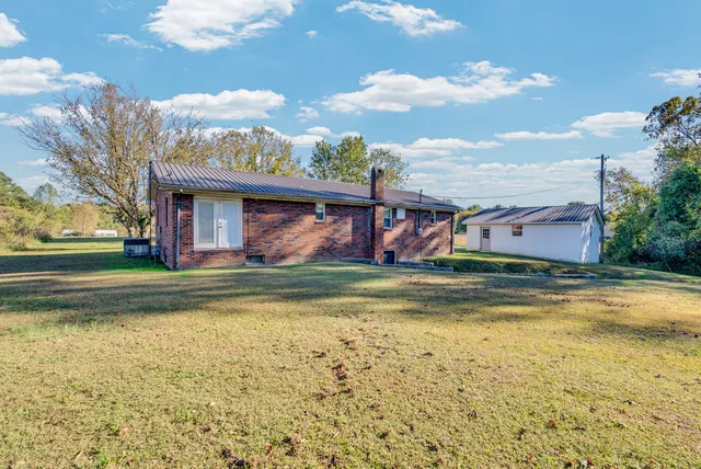 a view of a swimming pool with a yard
