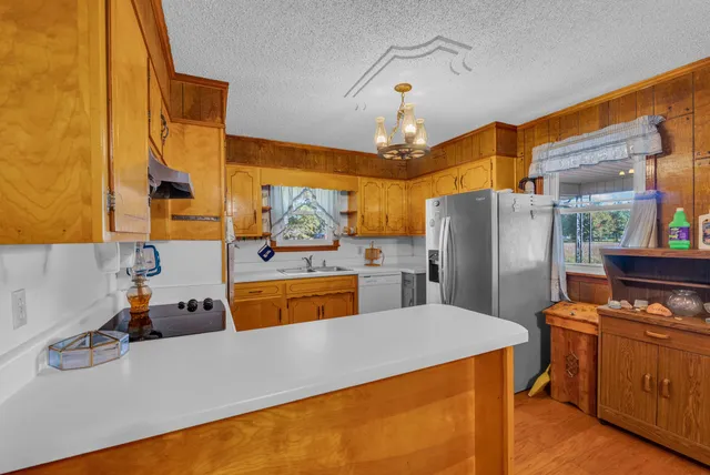 a kitchen with refrigerator and stove