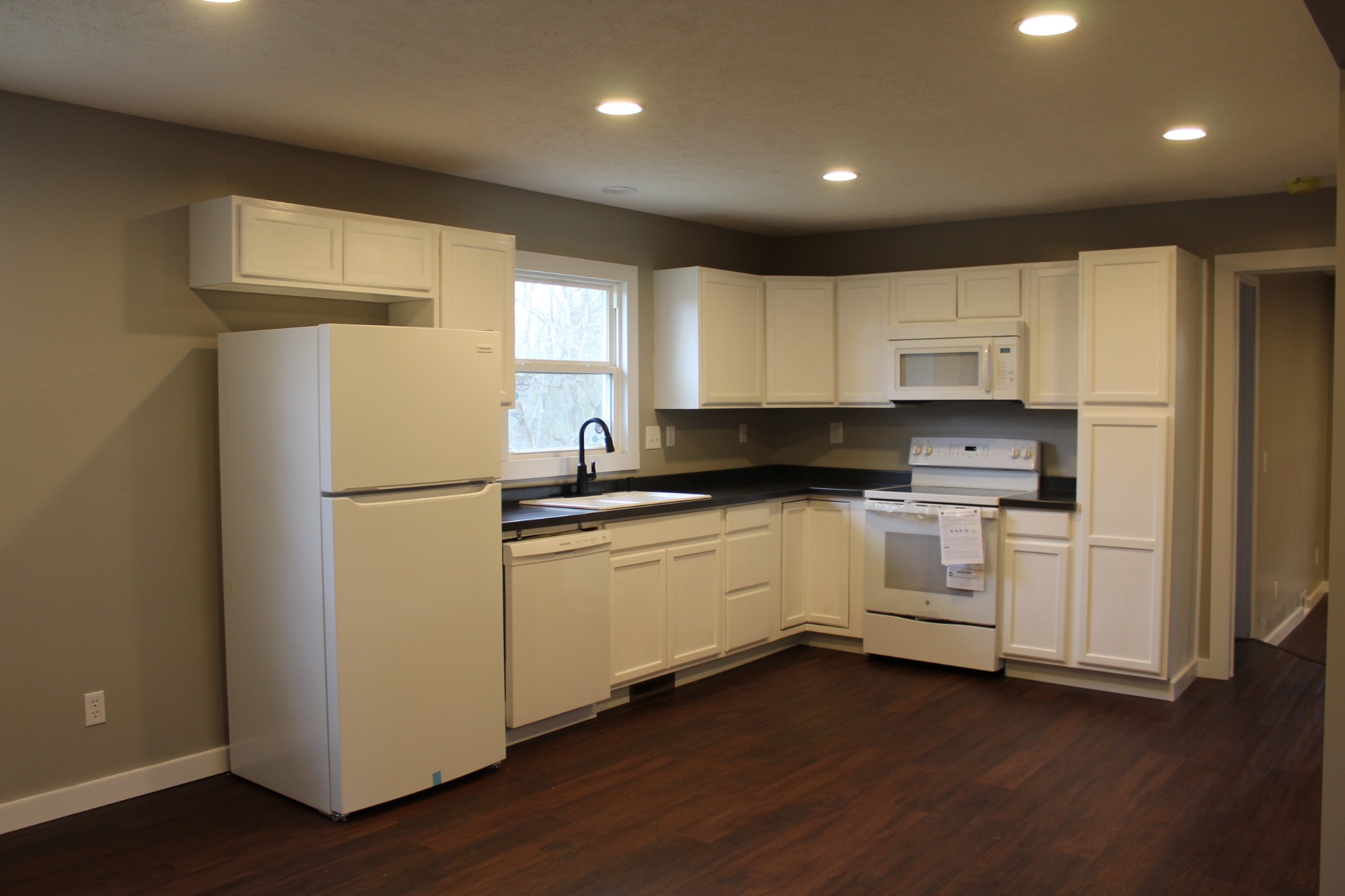 145 Locust Road Erin, TN 37061 - Photo 6 of 23 a kitchen with refrigerator a stove a sink and a window
