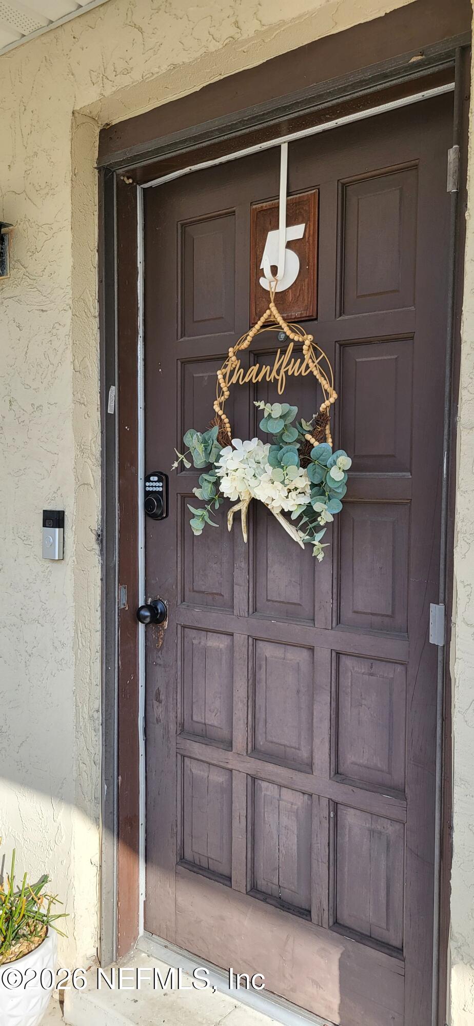1647 El Camino Road, Unit 5 Jacksonville, FL 32216 - Photo 29 of 36 a vase of flowers sitting on a wooden floor