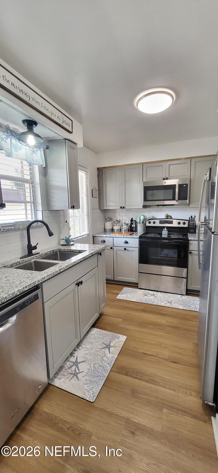 1647 El Camino Road, Unit 5 Jacksonville, FL 32216 - Photo 7 of 36 a kitchen with a stove a sink and a refrigerator