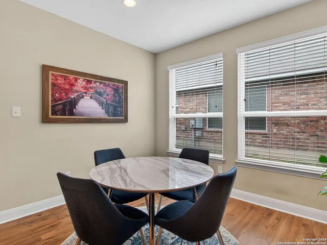 a view of a dining room with furniture window and wooden floor