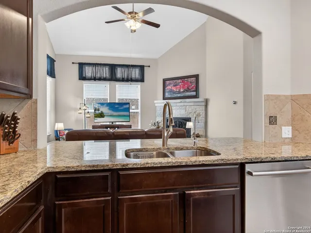 a kitchen with stainless steel appliances granite countertop a sink and a granite counter tops