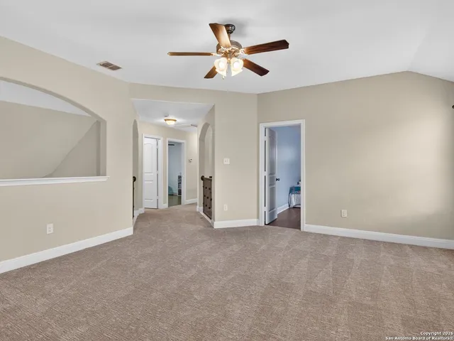 a view of a livingroom with a ceiling fan and window