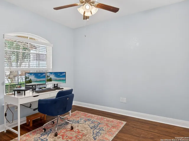 a room with stainless steel appliances wooden floor and a window